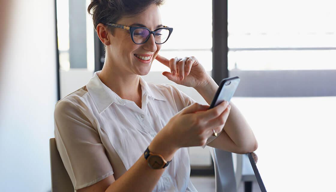 Woman Smiling at Phone completing Age Verification